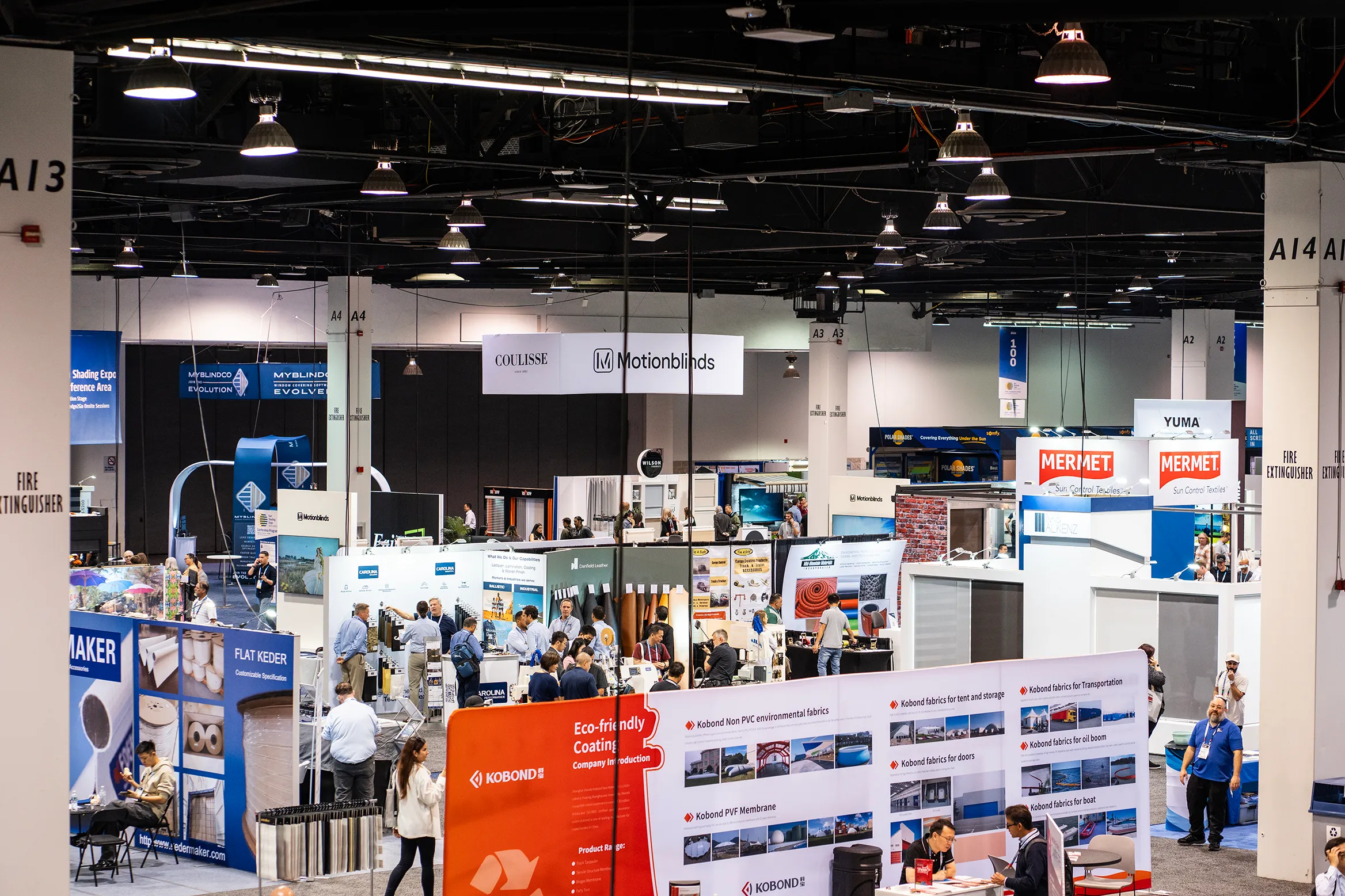 Attendees walking the Sun Shading Expo show floor between exhibitor booths